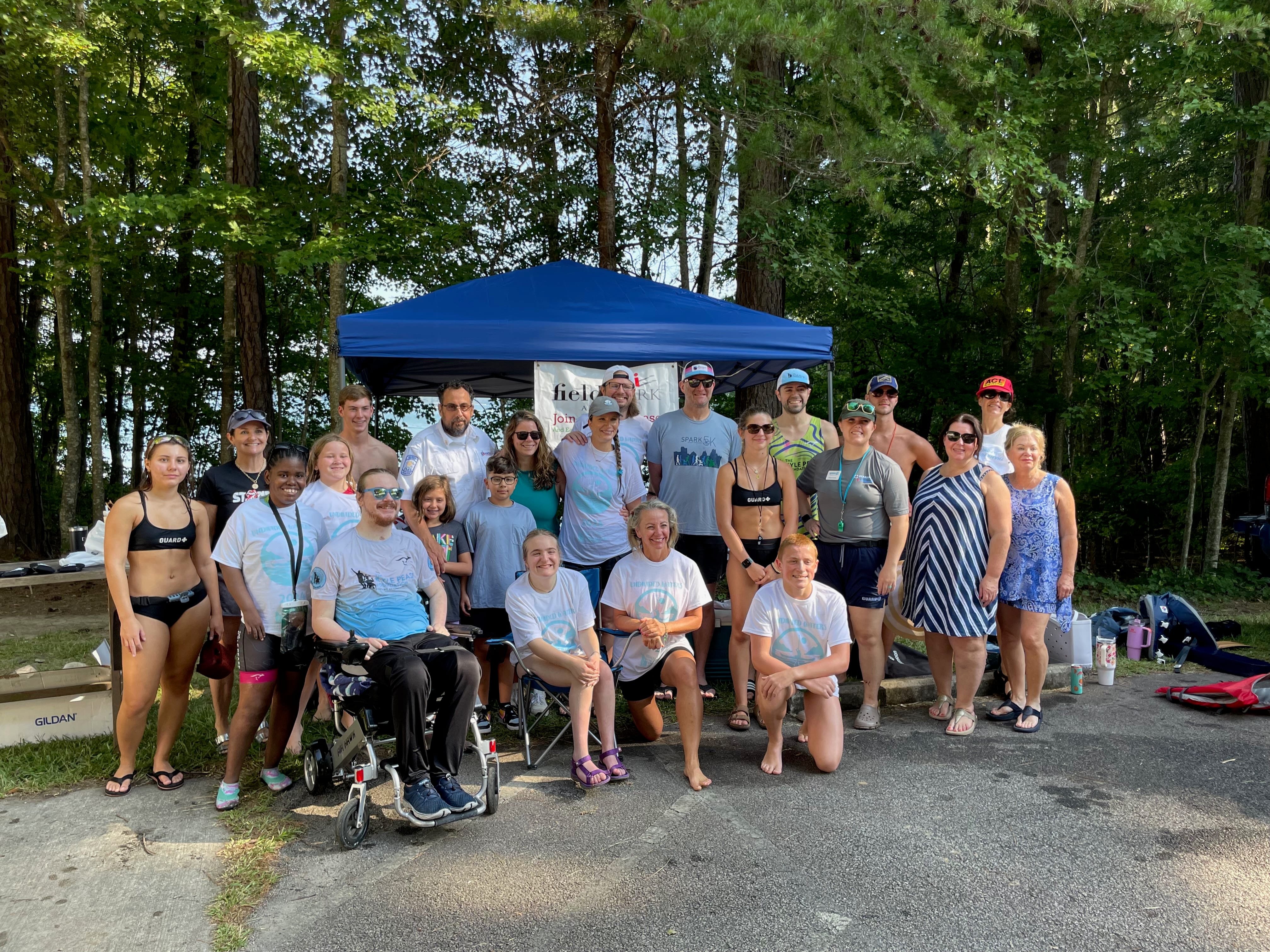 Team paddleboarding together across the lake